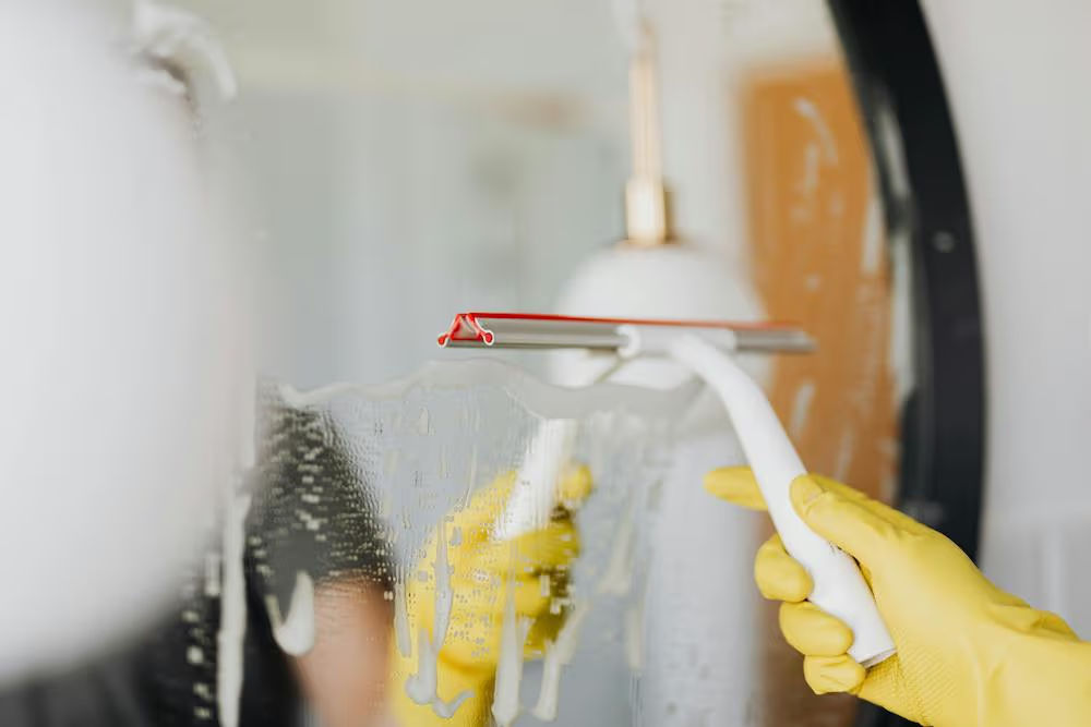 Professional cleaner wiping down a counter in a Pittsburgh home